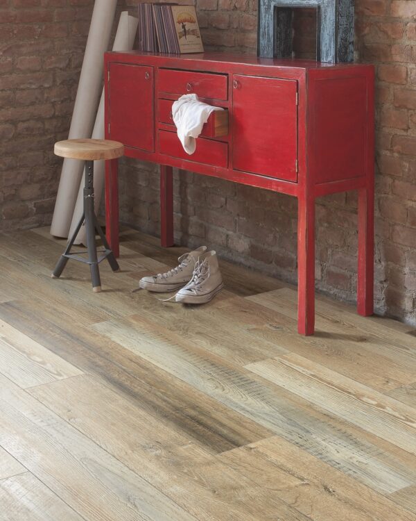 Detail houtlook laminaatvloer lange planken in woonkamer met dressoir.