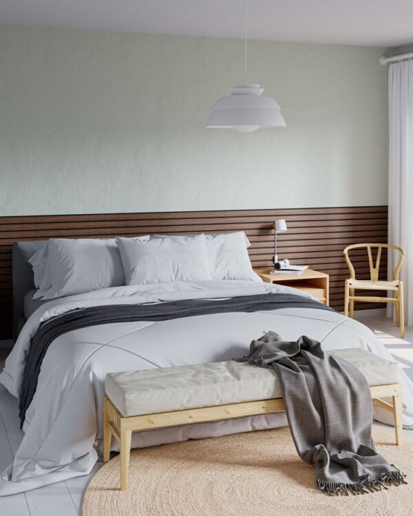 Slaapkamer met houten tweepersoons bed in Scandinavische stijl, lichtgroen behang en wandpanelen in de kleur walnoot achter het bed.