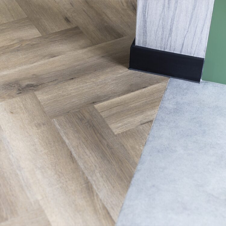 Visgraat pvc-vloer die aansluit op een betonlook vinylvloer