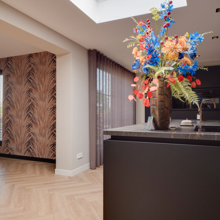 Keuken met bladeren behang. een visgraat vloer en bruine inbetweens