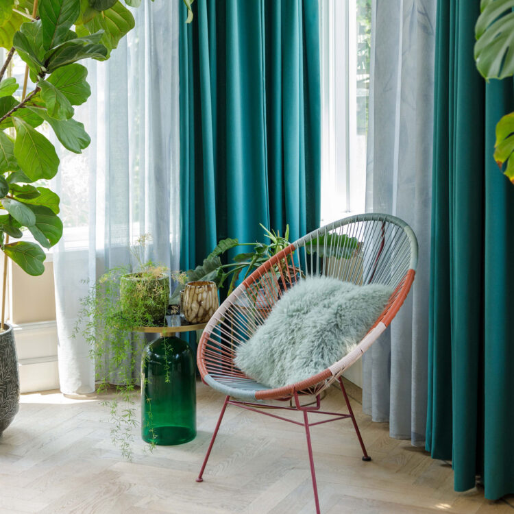 Blauwe vitrage en overgordijnen van Holland Haag in de zithoek